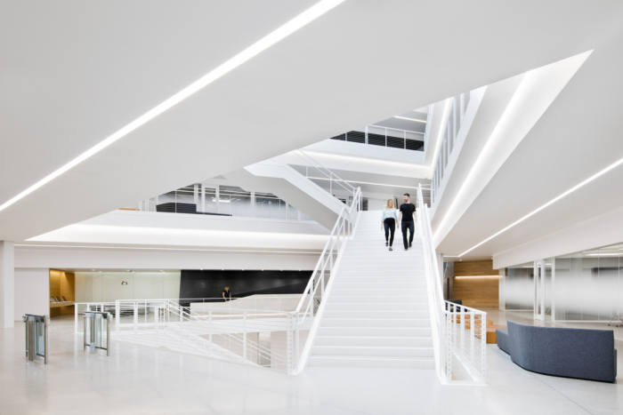 Example placeholder: bright white atrium stair with linear lighting
